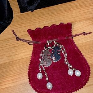 Silver face with dangling pearls earrings